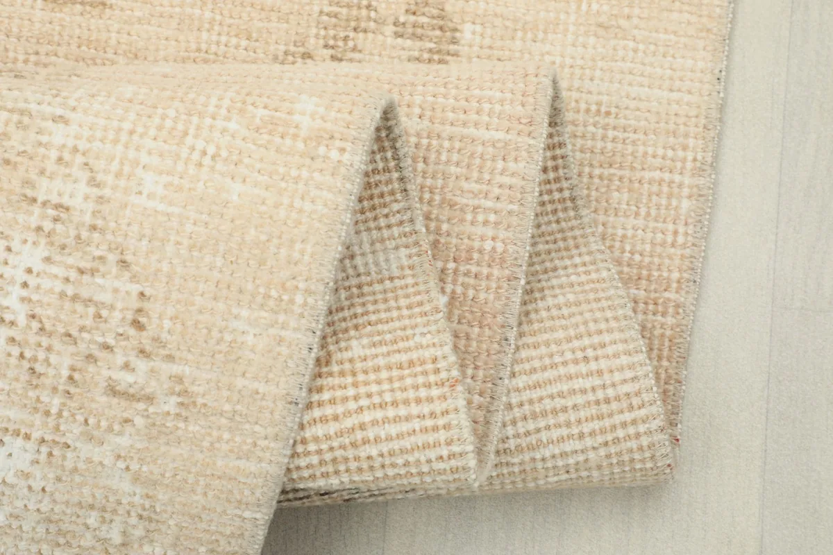 Close-up of the runner rug folded multiple times, highlighting the material and weave