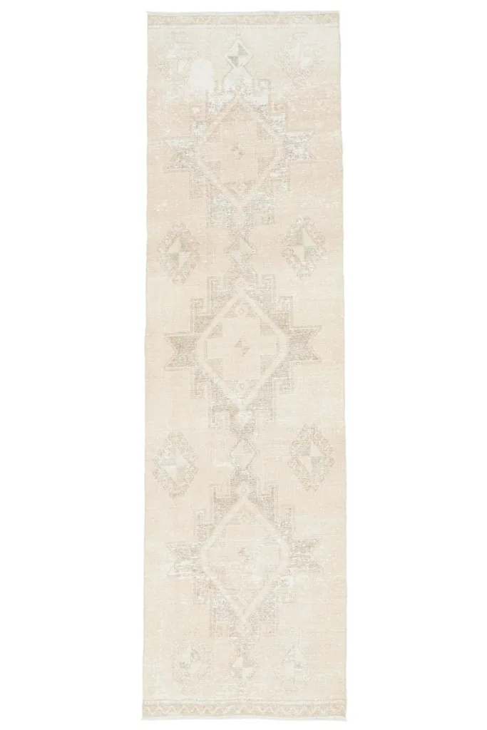 Full overhead view of the ivory geometric runner rug on a white background