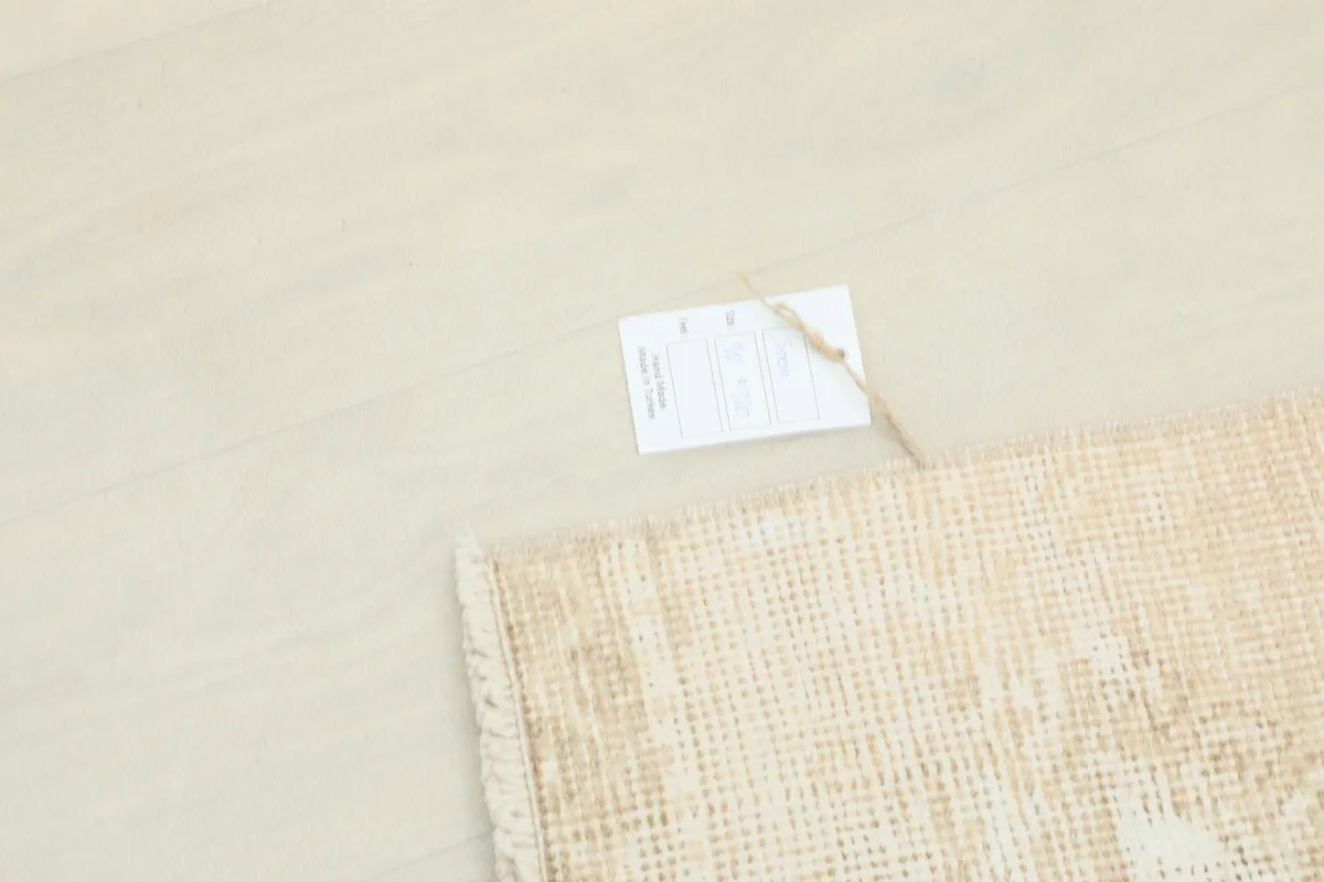 View of the rug's label on the floor next to the runner, showing product information