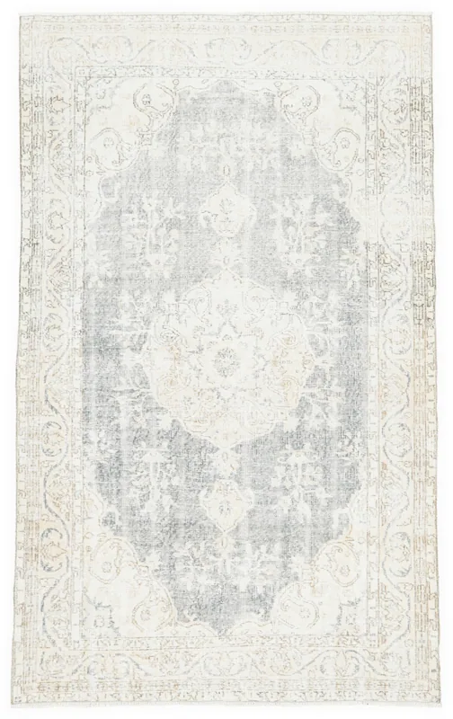 Top view of the 4'11" x 8'2" vintage gray and ivory Anatolian area rug with central medallion.