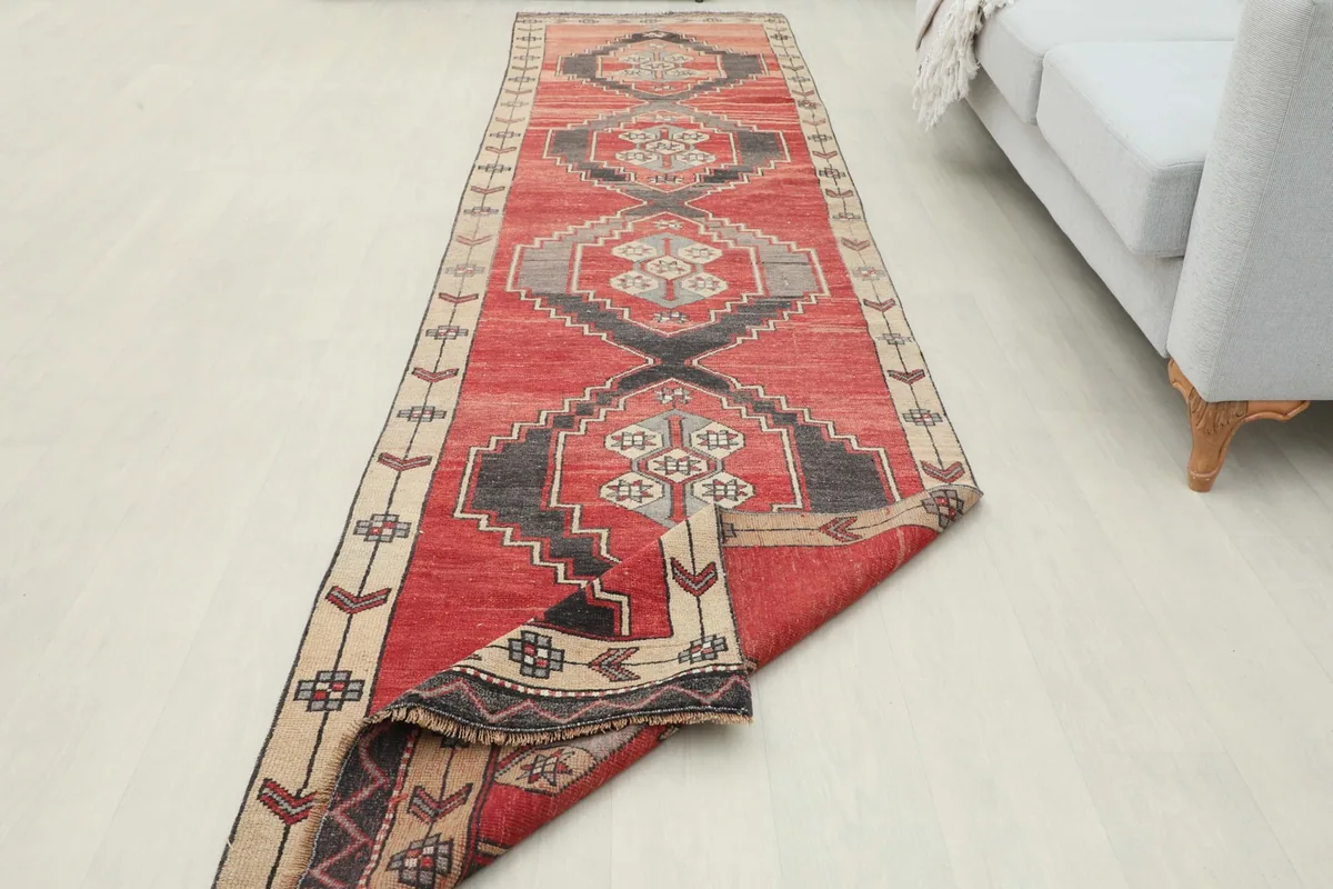 Wider room view with the runner partially folded, emphasizing its length and design