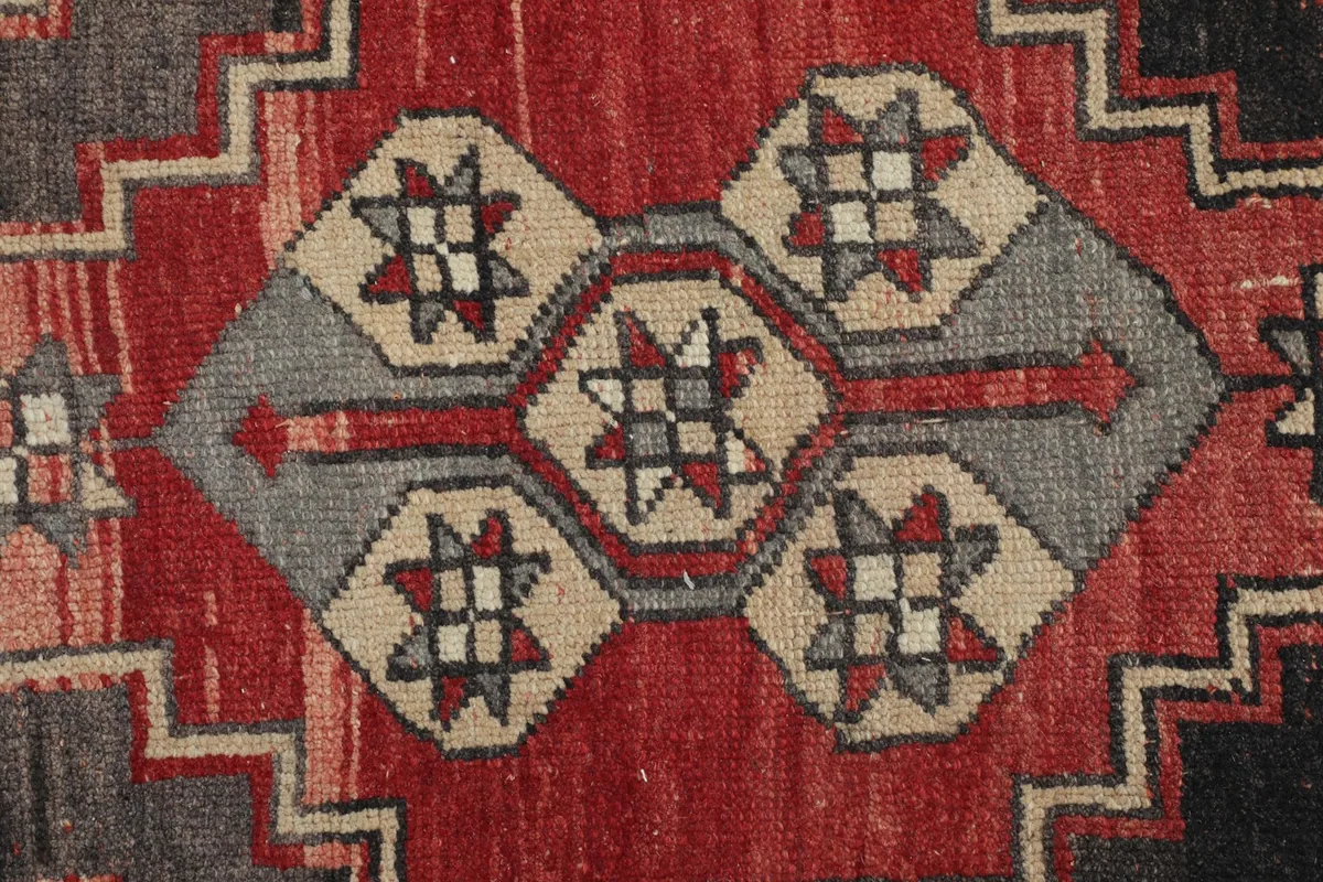 Close-up of an intricate star-like pattern within the geometric design of the rug
