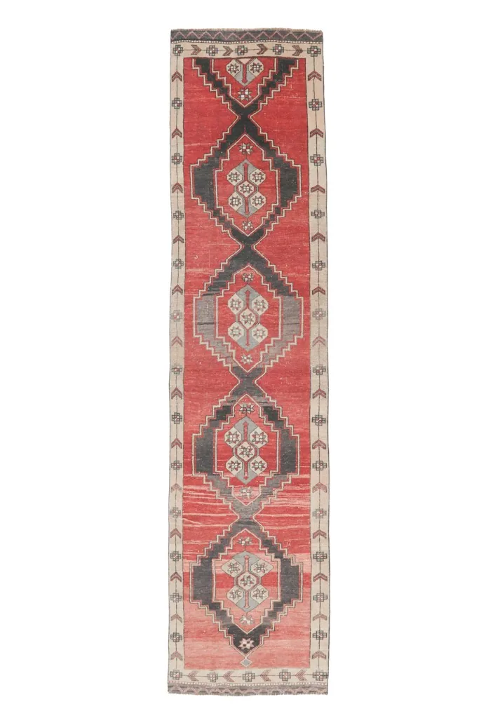 Full overhead view of the red and charcoal geometric runner rug from Anatolia