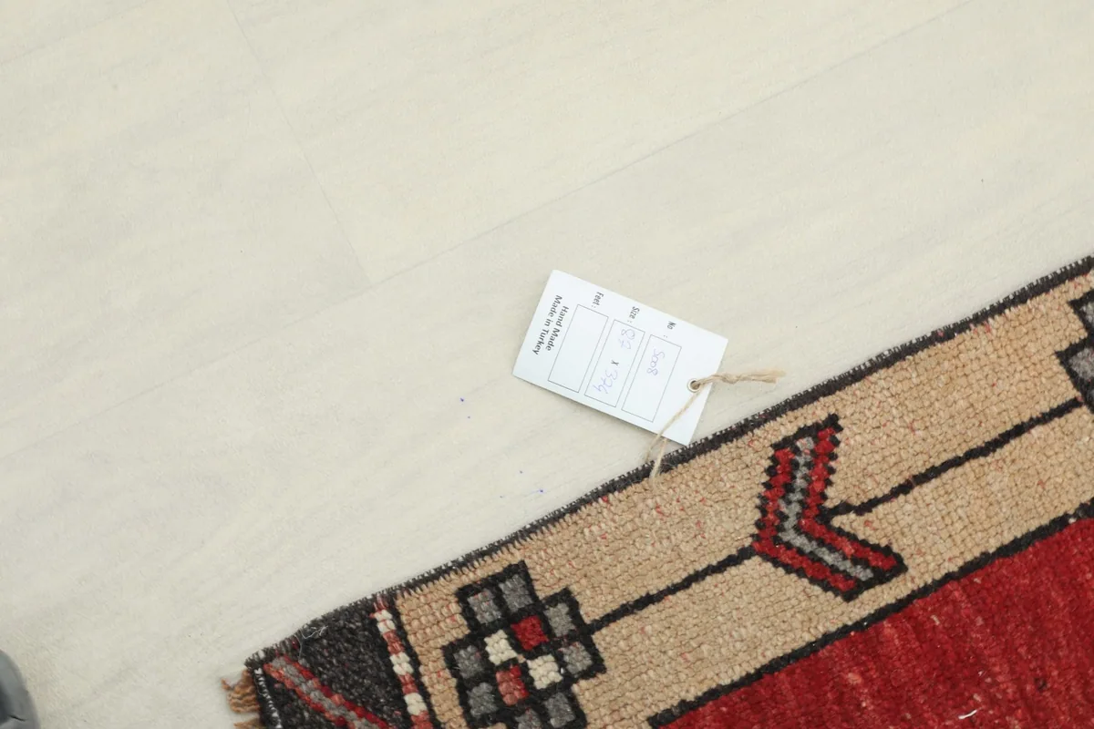 Overhead shot showing the product tag attached to the corner of the vintage runner