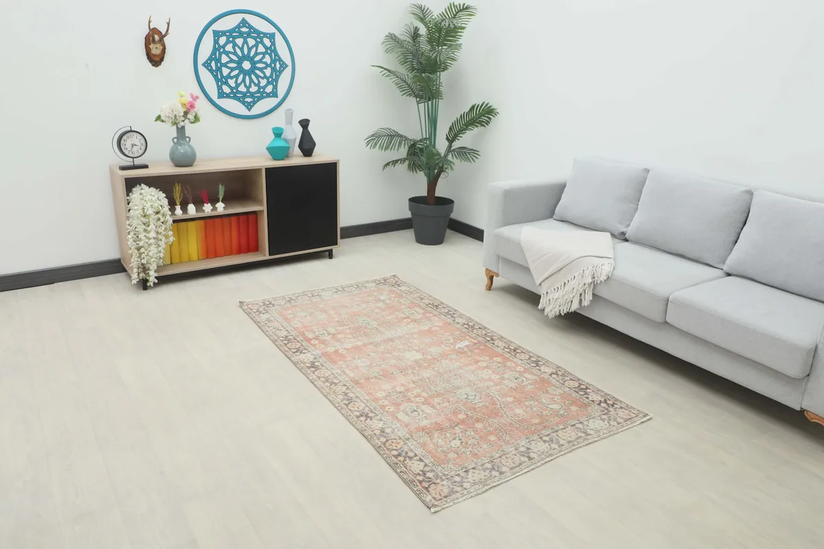 Rose and gray vintage Anatolian rug placed in a modern living room setting