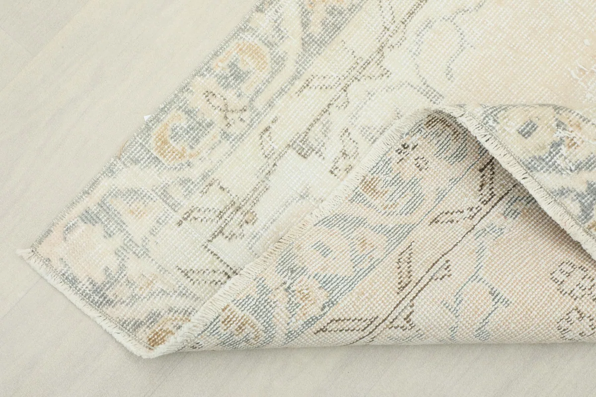 View of the back of the rug, showing the cotton foundation and knotting