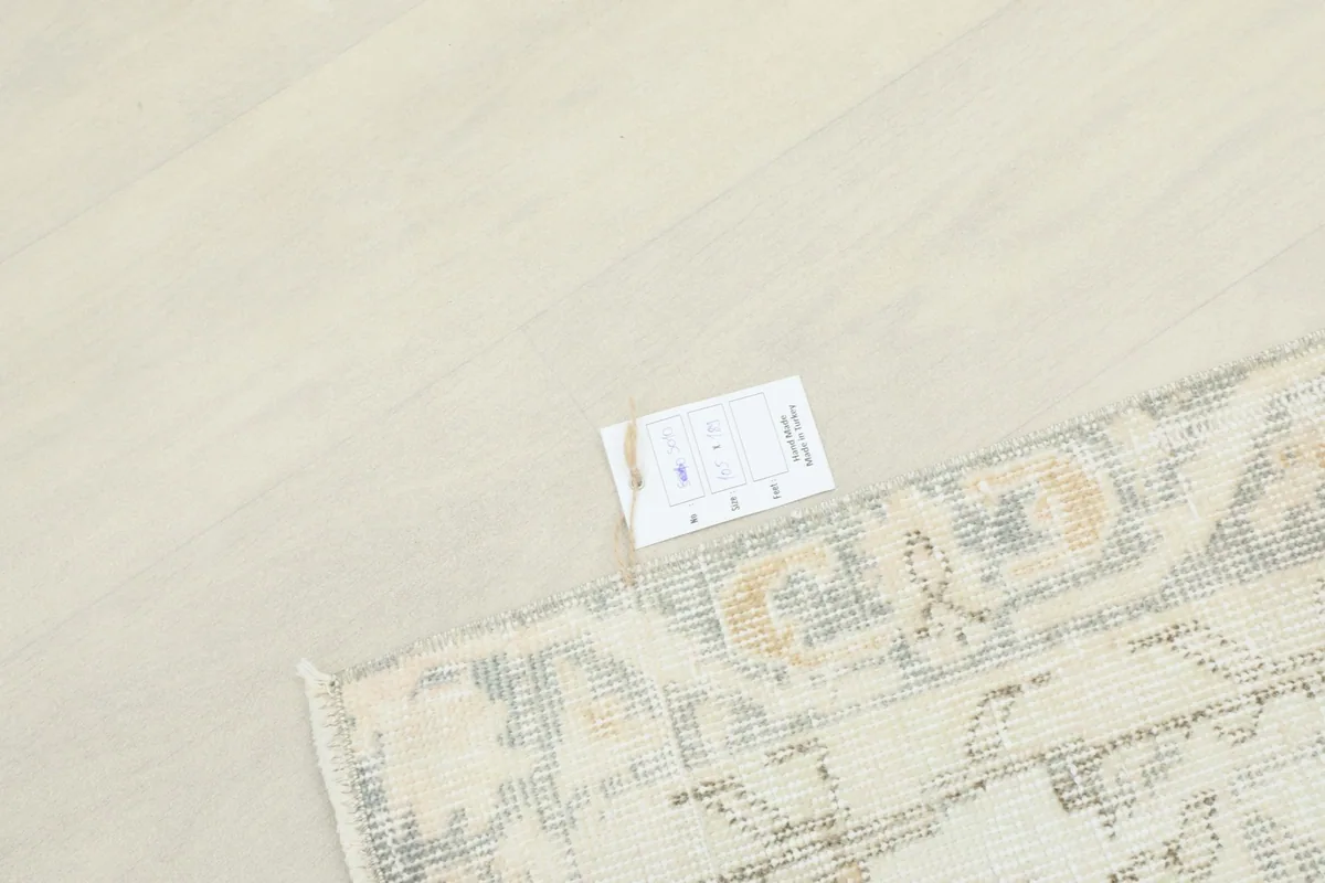 Rug corner with a product tag, indicating its authenticity and origin
