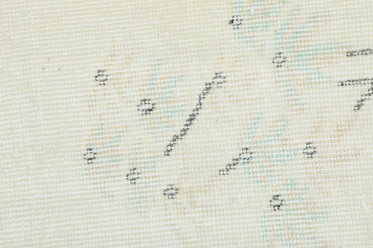 Extreme close-up of the hand-knotted pile, revealing individual knots and color variations