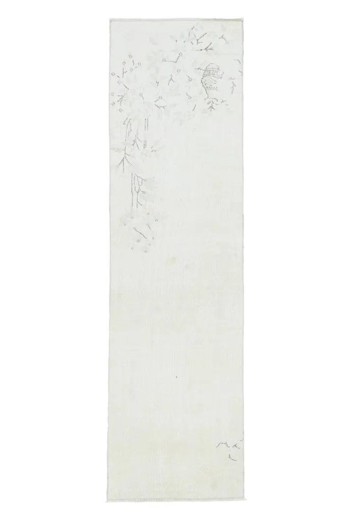 Full overhead view of the ivory runner rug, emphasizing its long, narrow shape