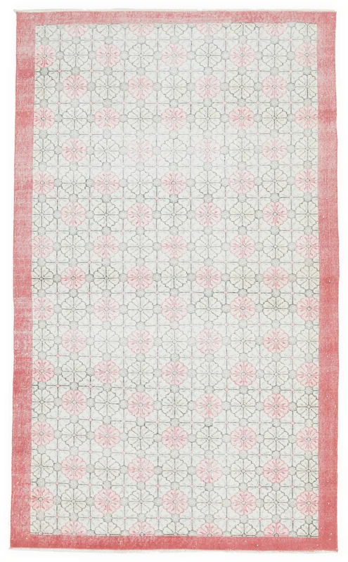 Full overhead view of the 5x9 vintage Anatolian rug with pink floral geometric pattern and red border.