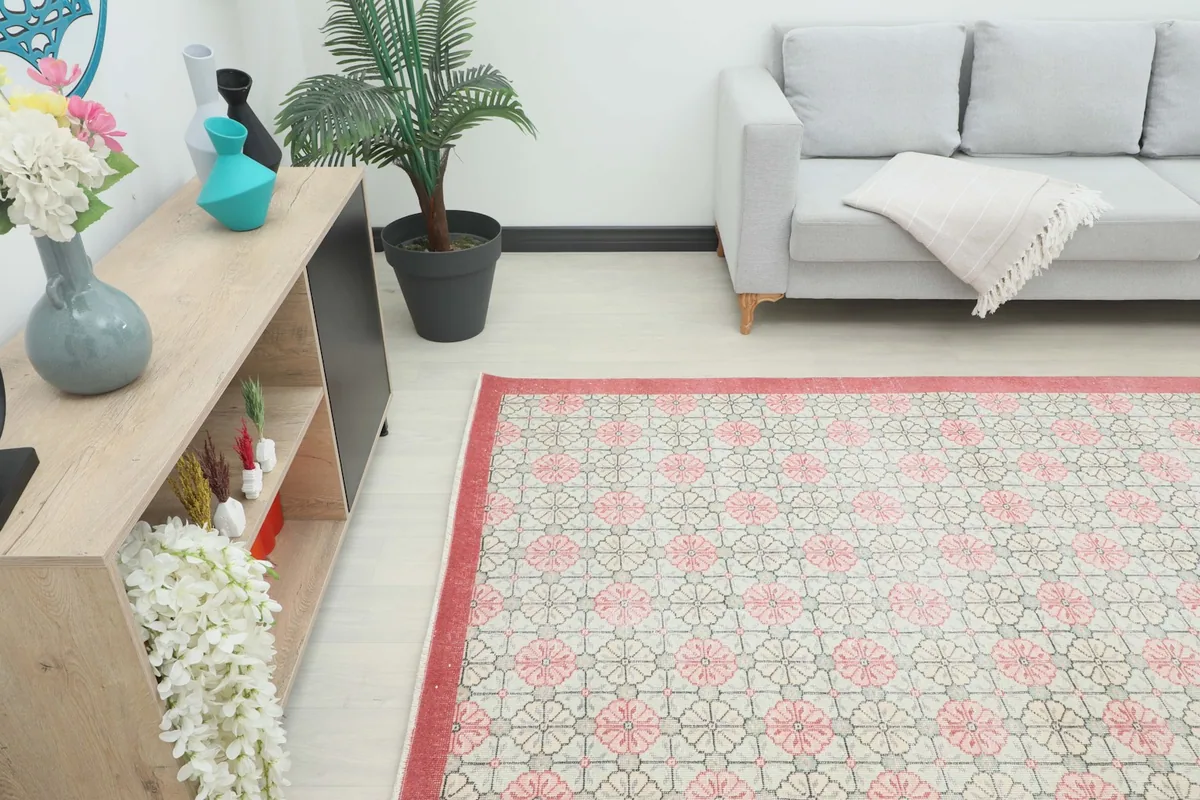 Angle view of the rug in a room, showing its placement relative to a console table and sofa.