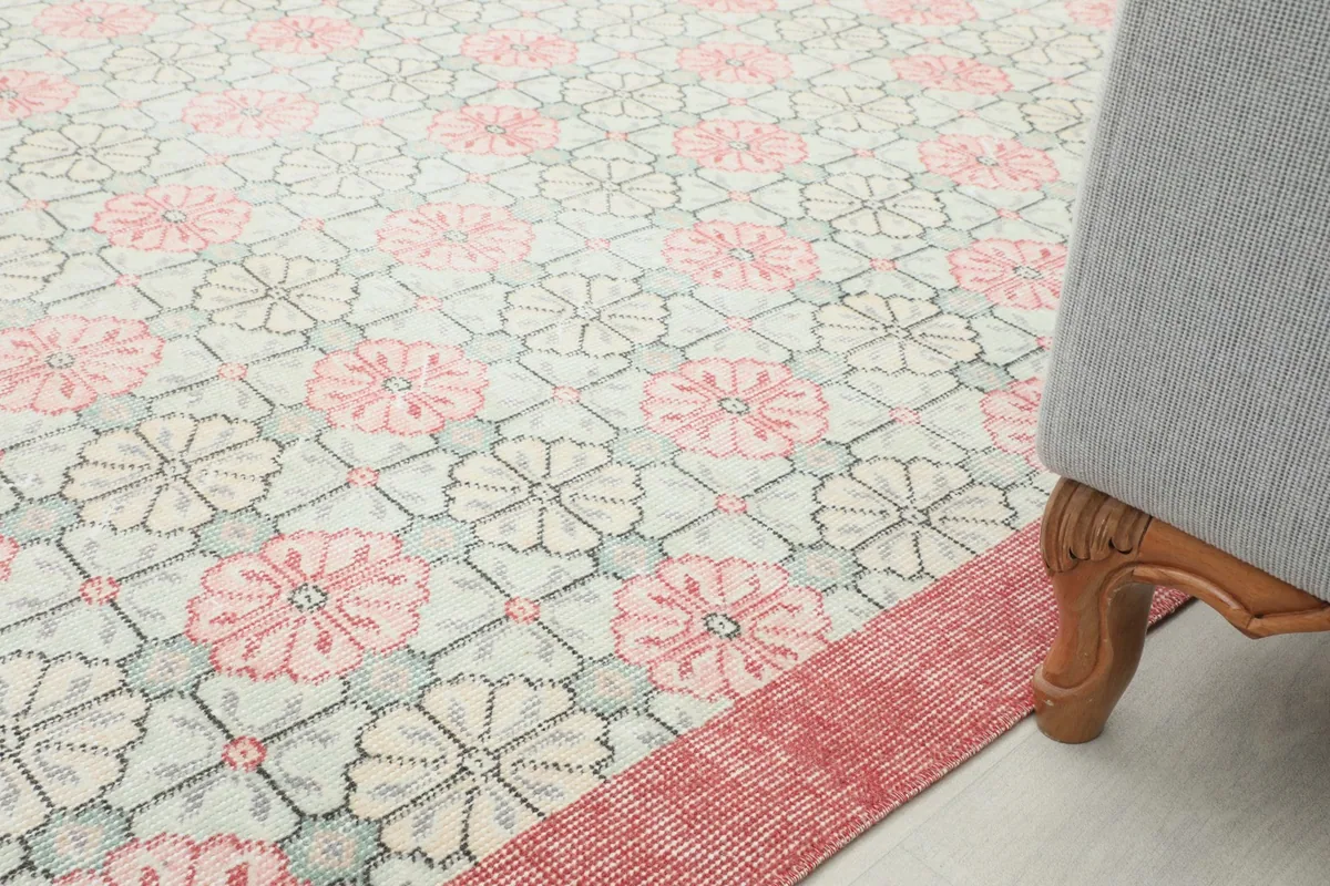 Rug placed under a piece of furniture, illustrating its scale and how it fits into a room.