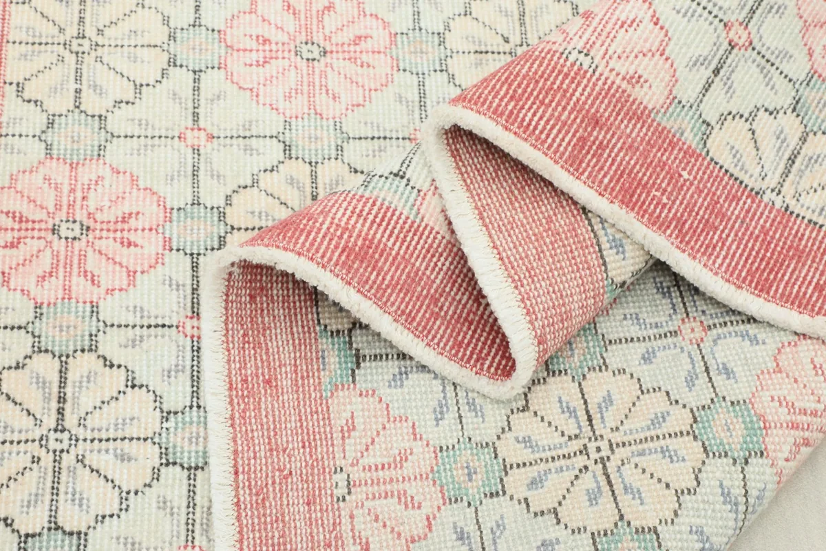 Folded section of the rug, showcasing the texture and the consistency of the hand-knotted pile.