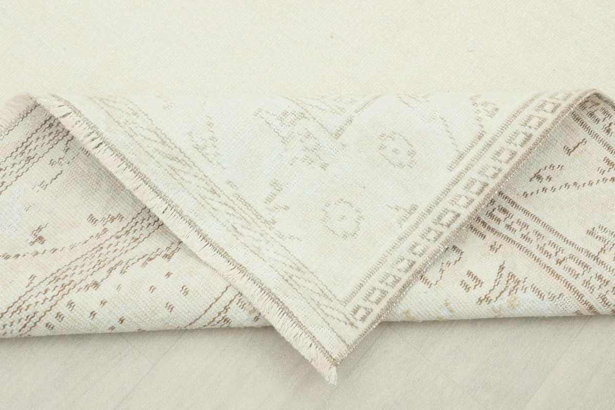 Rug corner folded to show the thickness and flexibility of the hand-knotted wool pile.