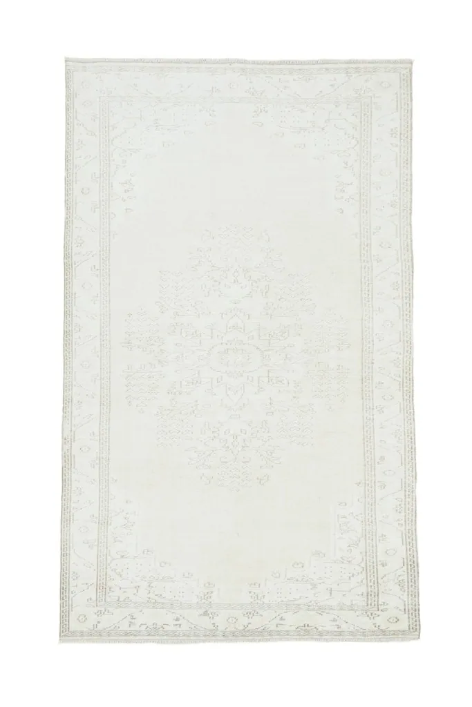 Full overhead view of the 5'7" x 9'6" ivory vintage rug, showcasing its complete design.
