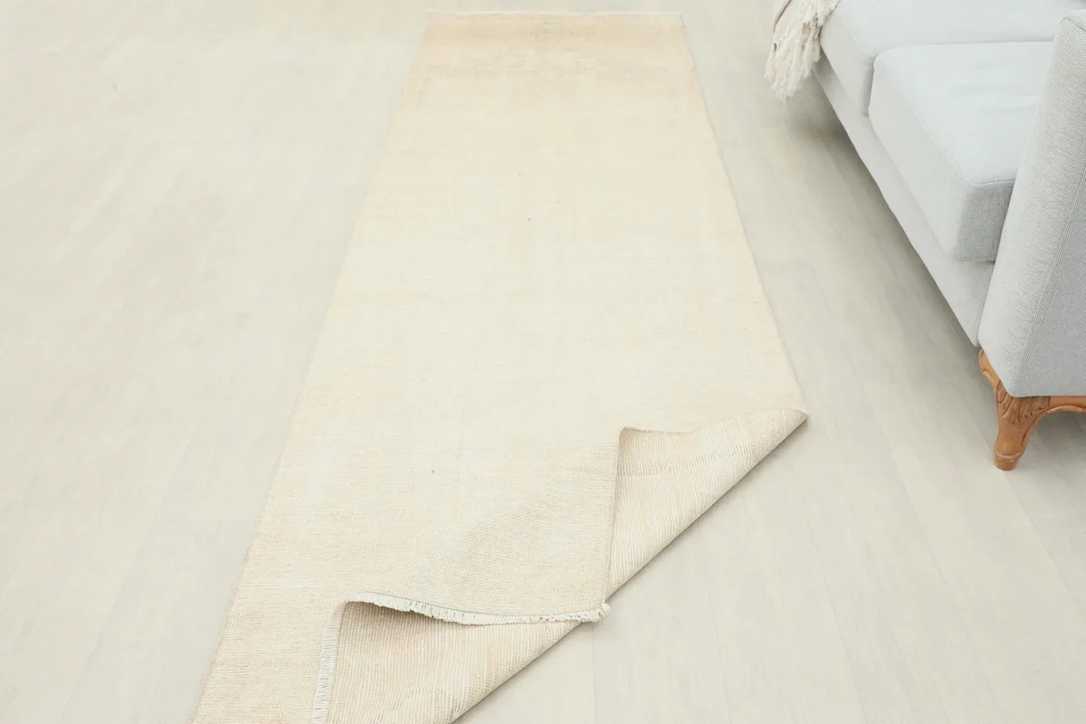 Runner rug partially folded, showcasing its flexibility and the underside of the pile