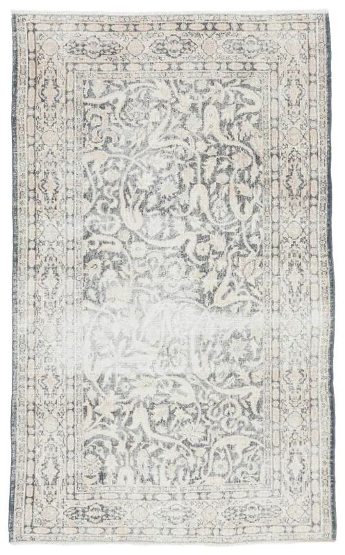 Full top view of the gray and beige floral vintage rug on a white background