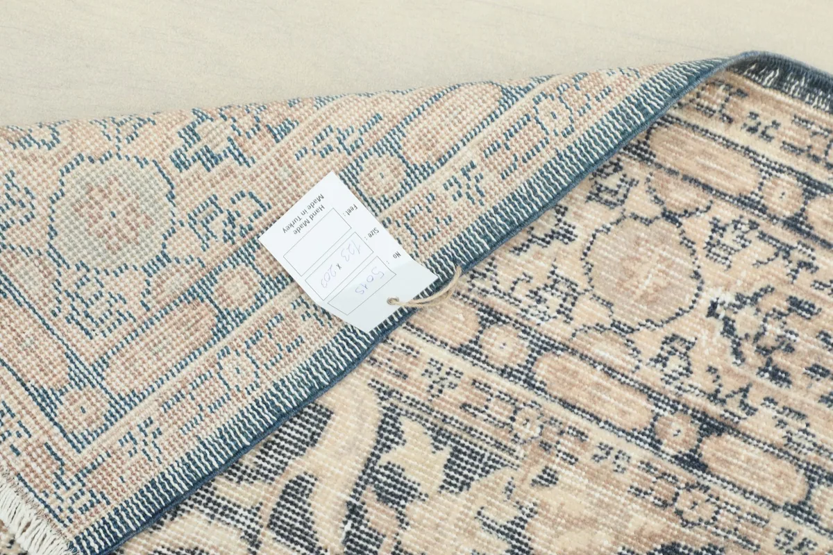 Overhead view of the back of the rug with an information tag attached
