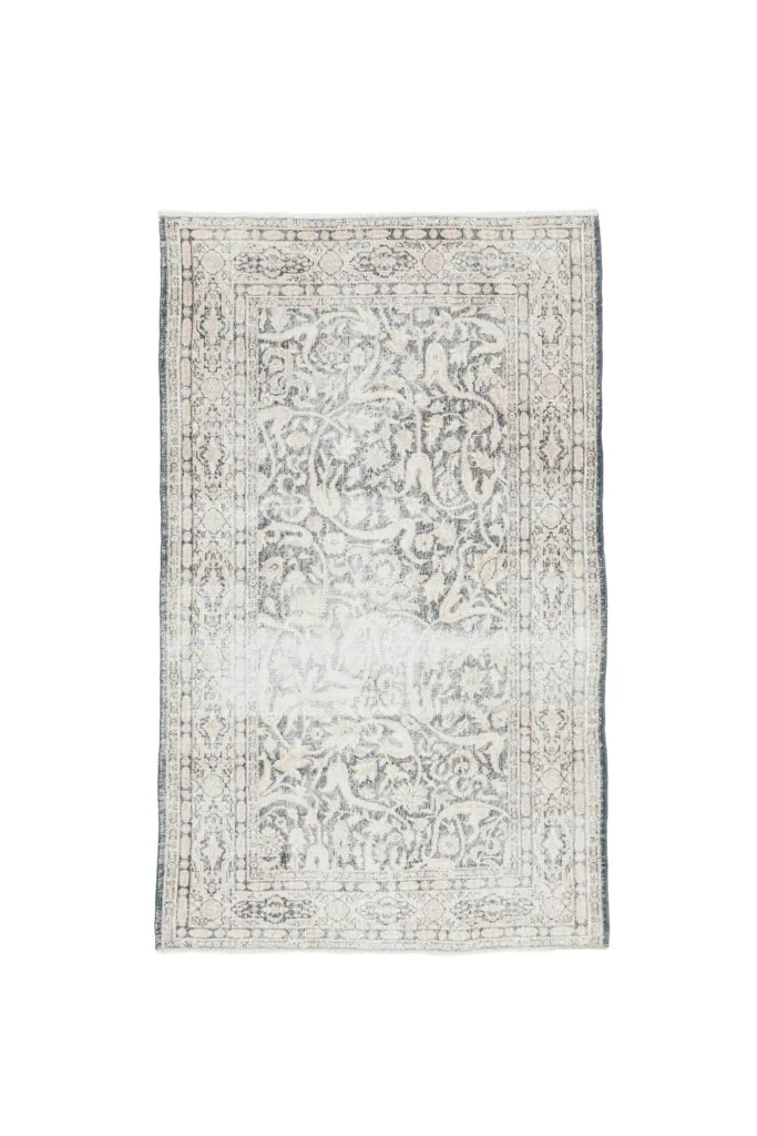 Full top view of the gray and beige floral vintage rug, isolated on a white background