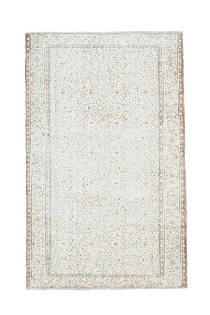 Full overhead view of the 5'3" x 8'6" cream vintage rug on a white background