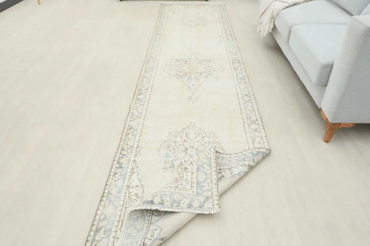 Runner partially rolled up, showing the flexibility and texture of the vintage wool pile