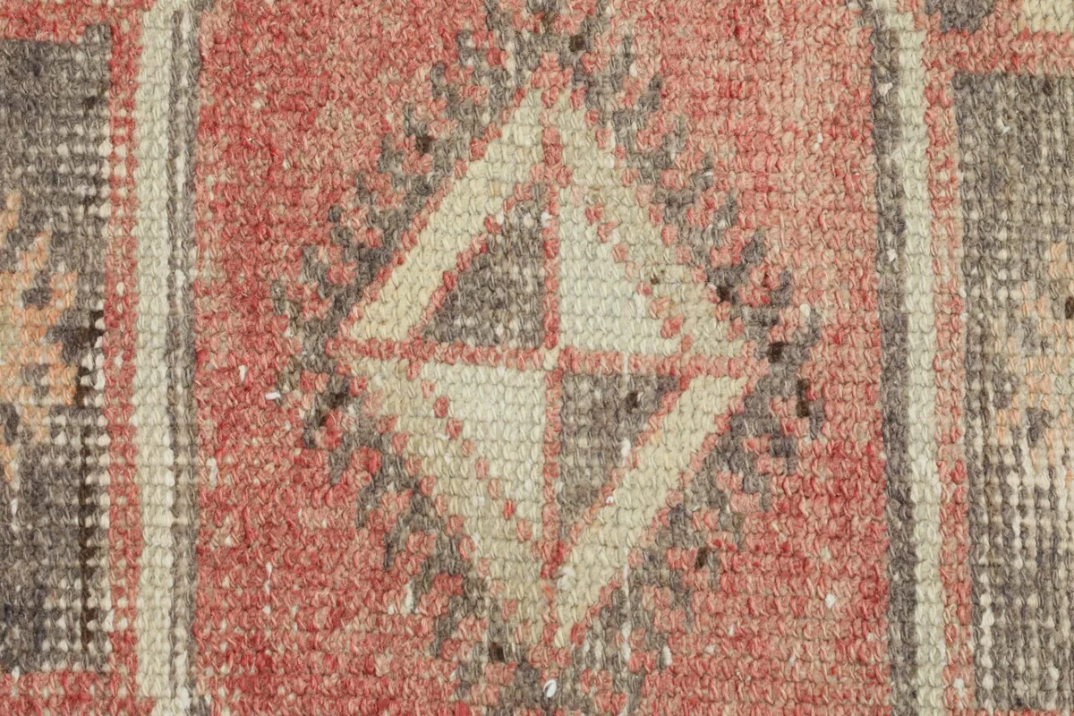 Close-up of the hand-knotted wool pile, showing texture and color variations