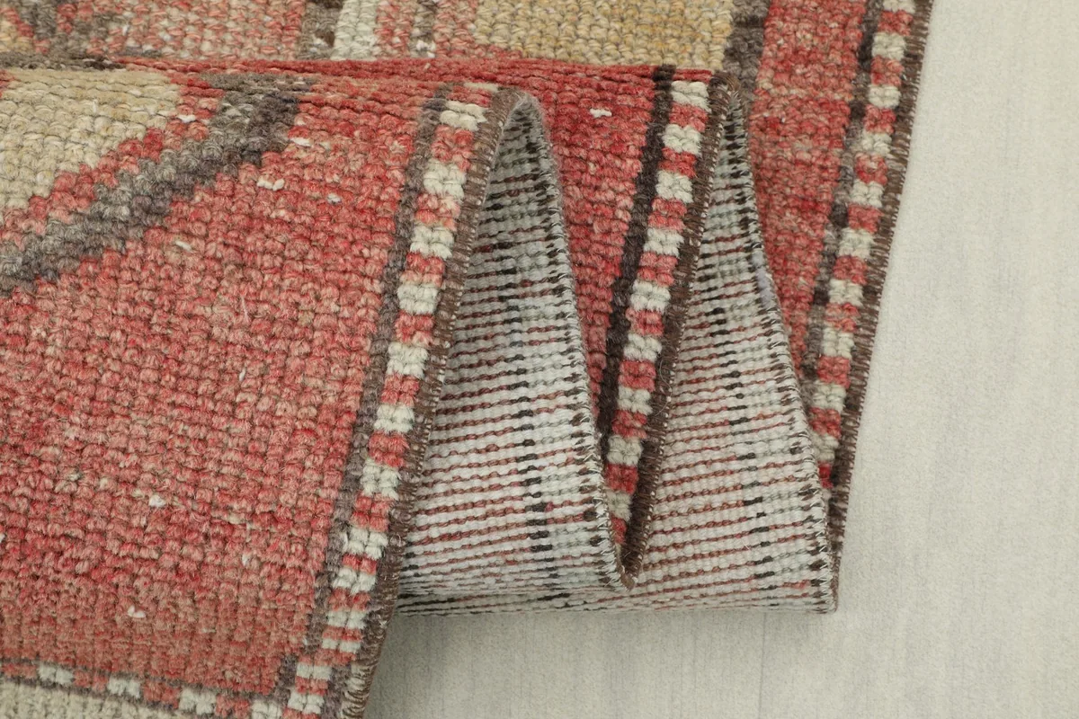 Close-up of the rug folded, showing the thickness of the pile and fringe details