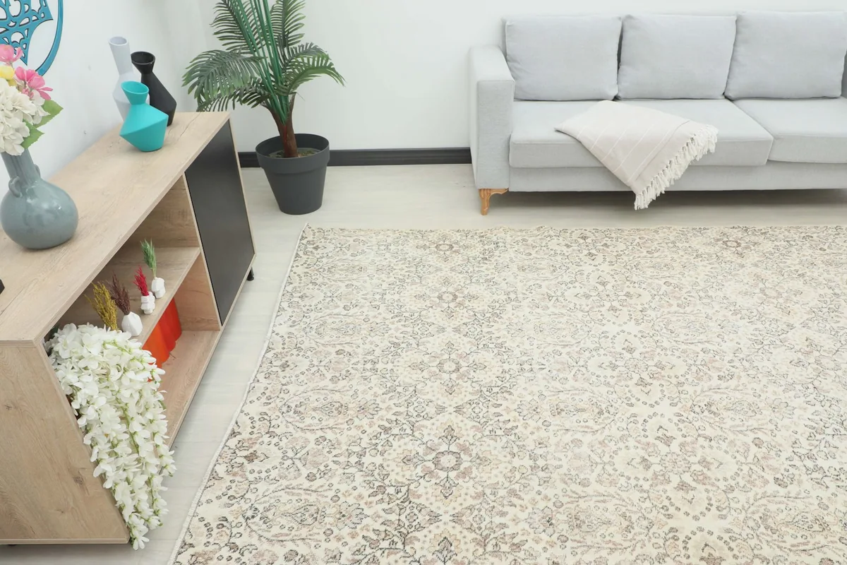 Vintage ivory rug in a spacious room, showcasing its size and aesthetic next to a sofa
