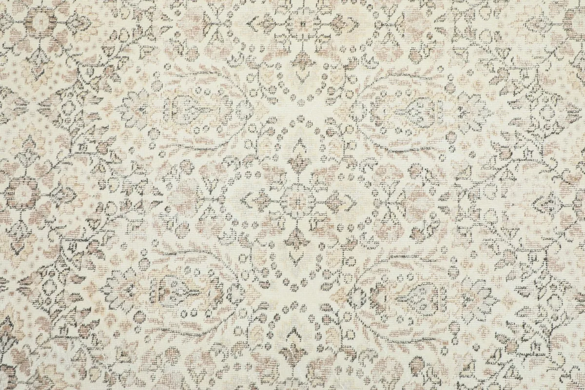Overhead view of the rug's central botanical medallion and repeating floral patterns