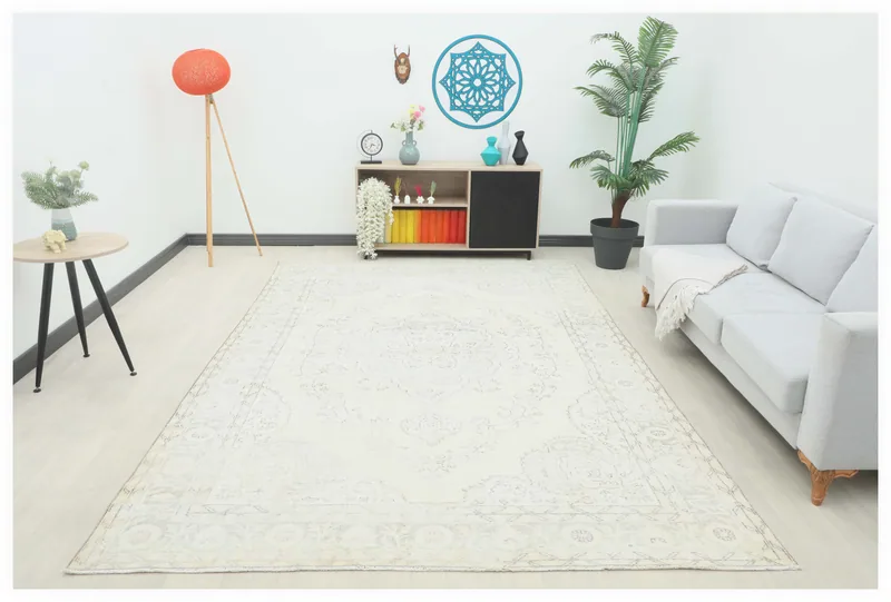 Full overhead view of the ivory and gray vintage Anatolian rug on a white background