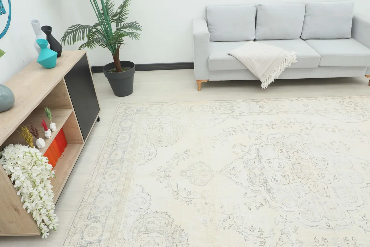 Angle view of the ivory rug in a living room, showing its scale next to furniture