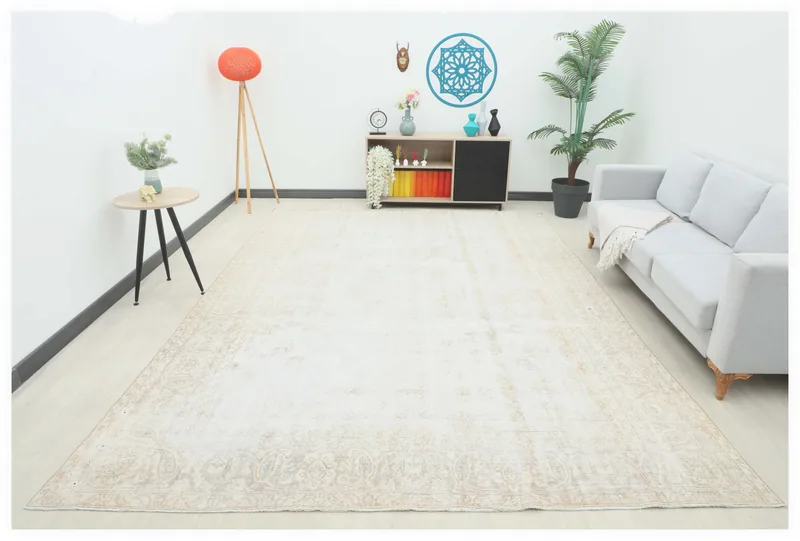Full top view of the 8'10" x 12'1" ivory beige vintage Anatolian rug on a white background.