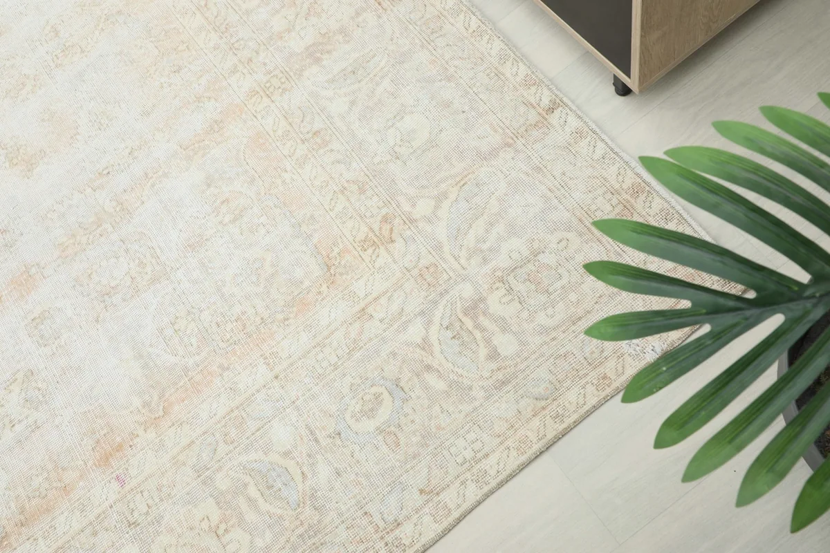 Overhead angle shot highlighting the rug's faded patterns and soft color variations.