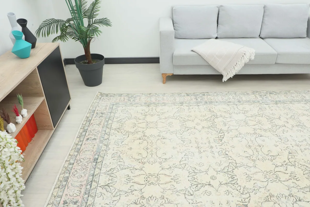 Angled view of the rug in a room, highlighting its placement next to furniture