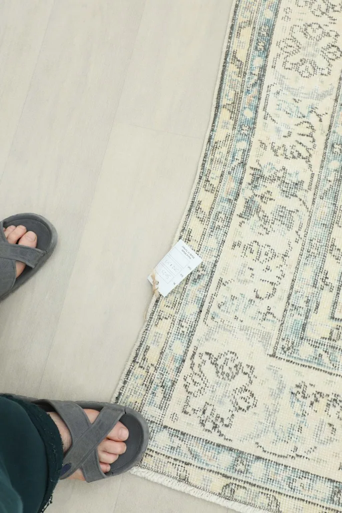 Overhead view of a section of the rug, showing scale with feet for reference