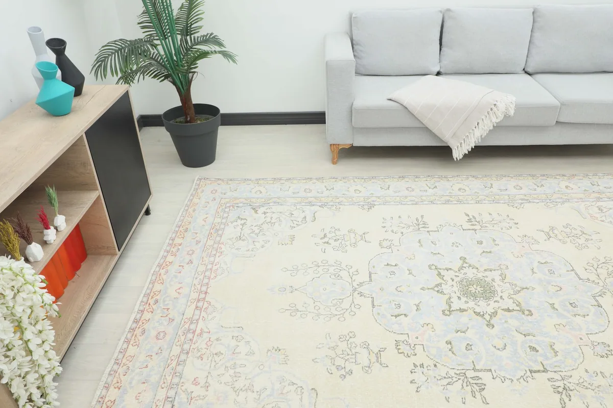 Overhead view of the vintage rug from a higher angle, showcasing its placement in a room with furniture.