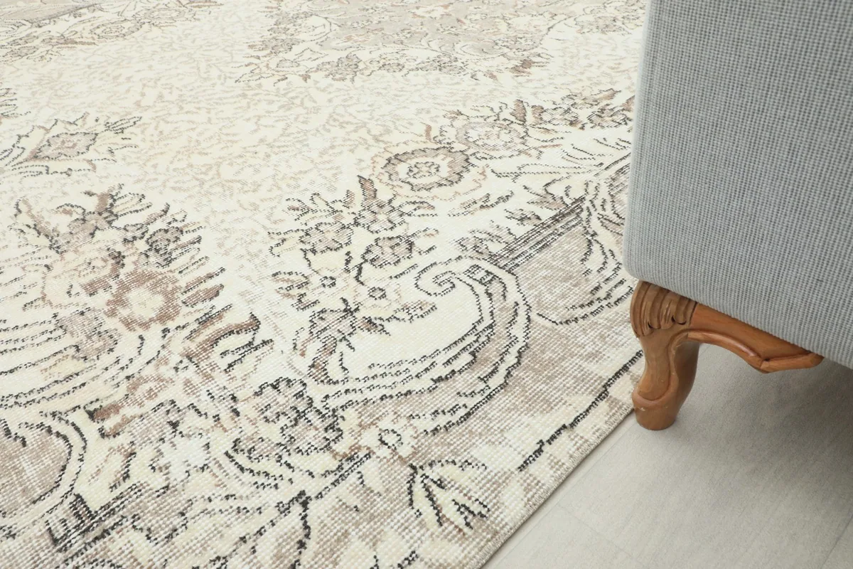 Rug placed under a light gray sofa, showing how it fits into a home decor setting