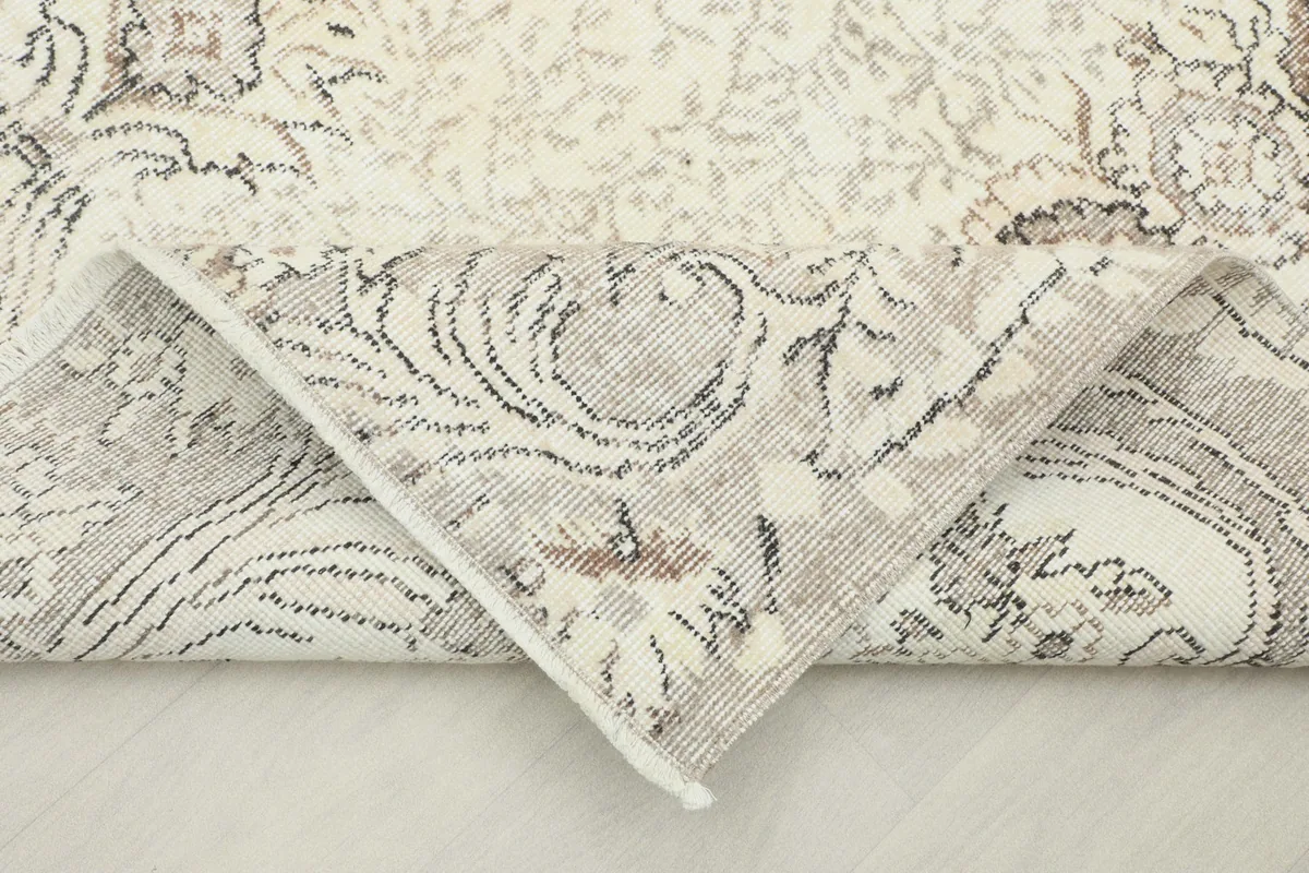 View of the rug's reverse side, revealing the hand-knotted cotton foundation