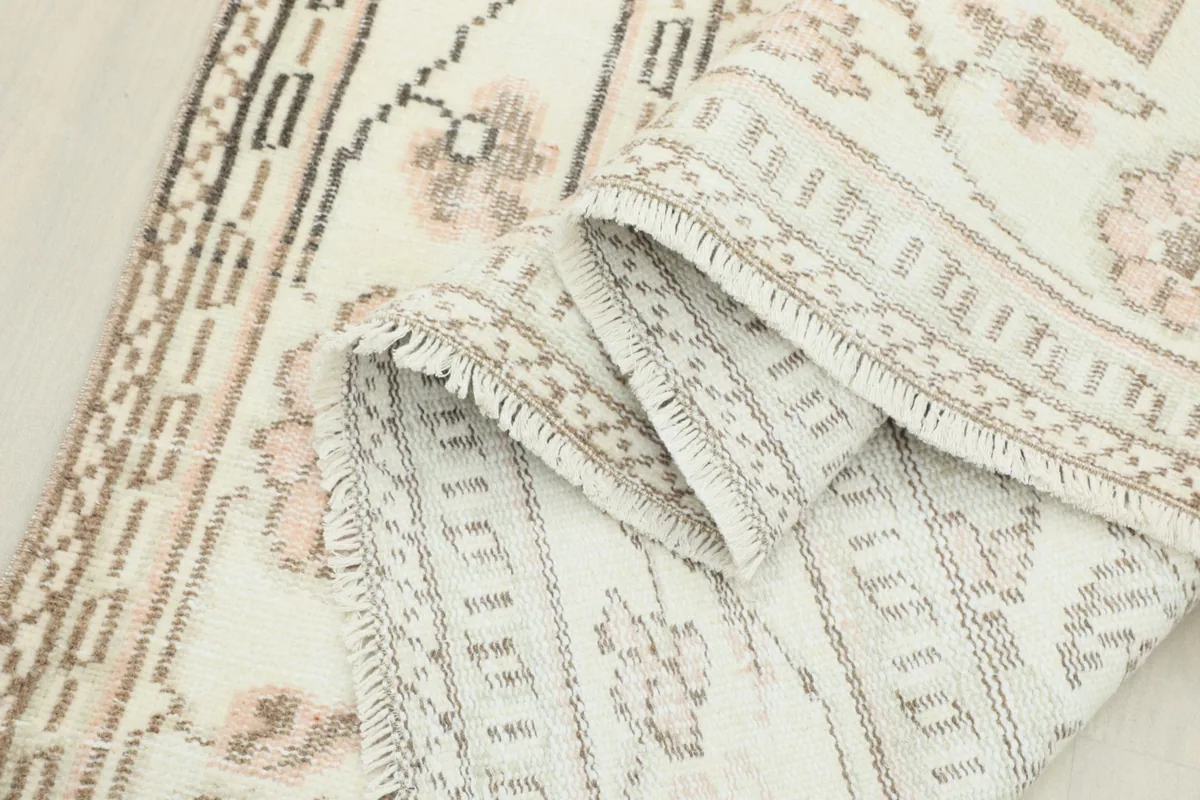 Rolled section of the rug showing the thickness and texture of the hand-knotted wool pile