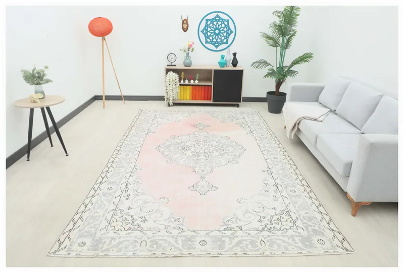 Full top view of the 6'11" x 10'10" pink and gray vintage Anatolian area rug on a white background.