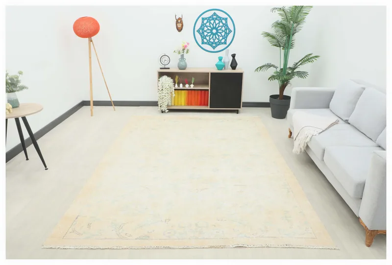 Full top view of the 6'9" x 9'7" ivory and blue vintage Anatolian area rug on a white background.