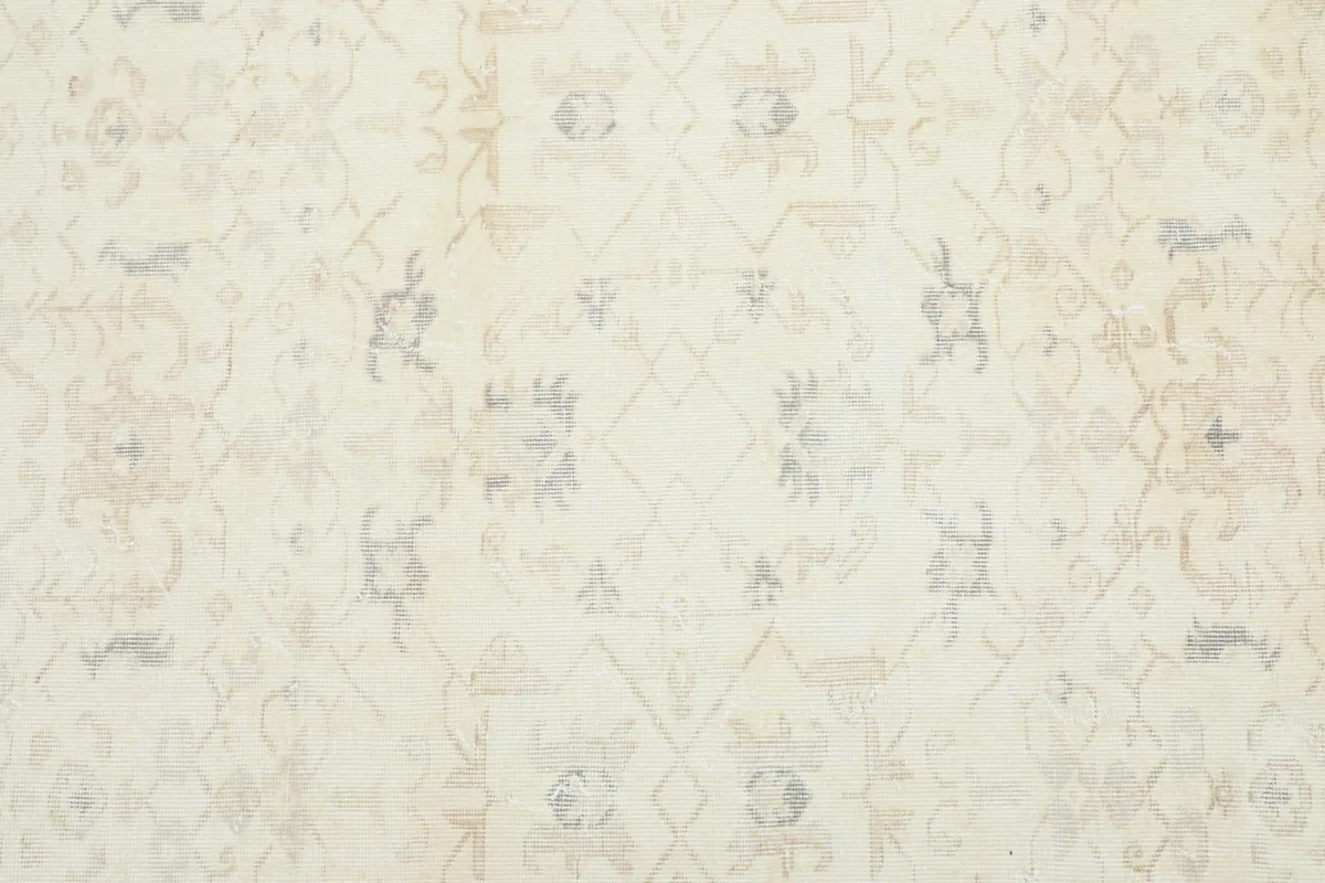 Close-up of the main field, revealing subtle cream and beige floral patterns.