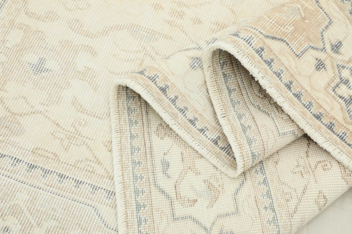 Multiple folds of the rug, displaying the thickness and construction of the vintage piece.
