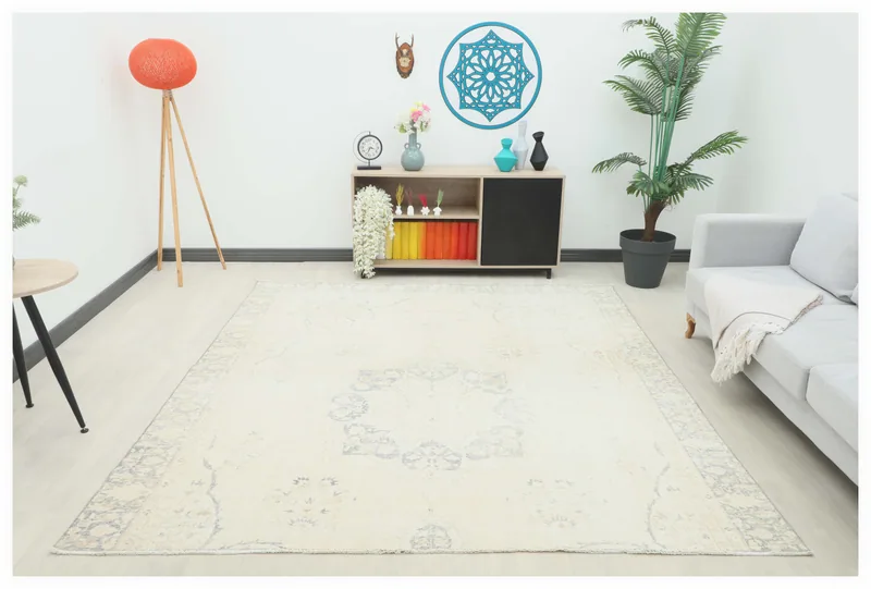 Full top view of the cream and gray vintage Anatolian rug on a white background