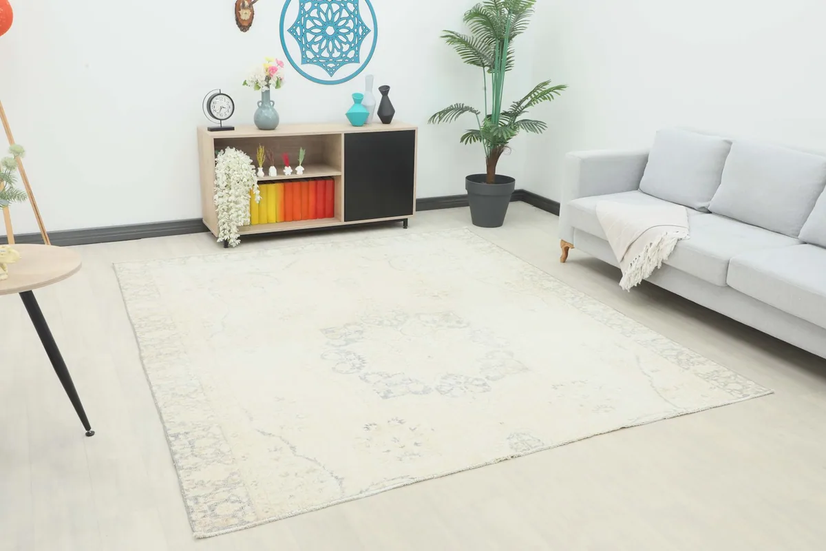 Vintage Anatolian rug in a room setting with a light gray sofa and wooden console