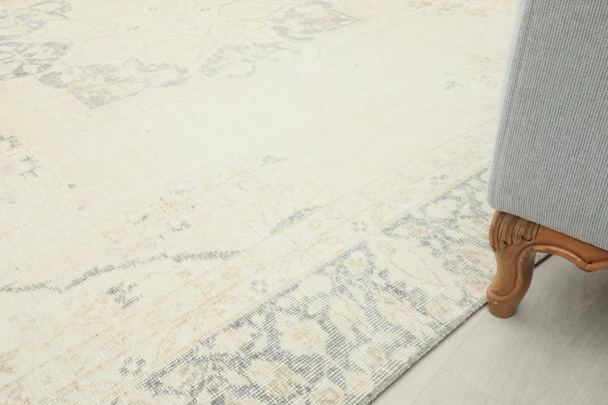 Close-up of the rug next to a sofa leg, demonstrating its placement in a room