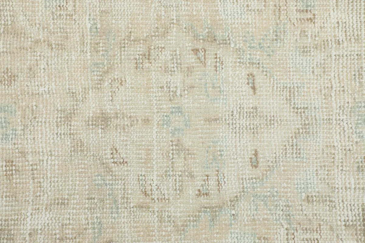 Close-up texture of the low wool pile, revealing the hand-knotted weave and subtle color shifts