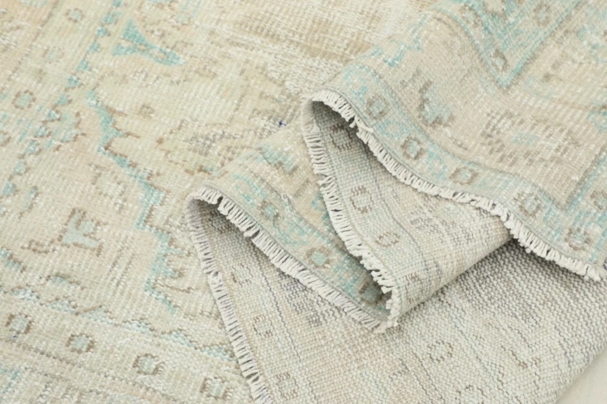 Folded section of the rug, showing the flexibility and thickness of the vintage wool pile