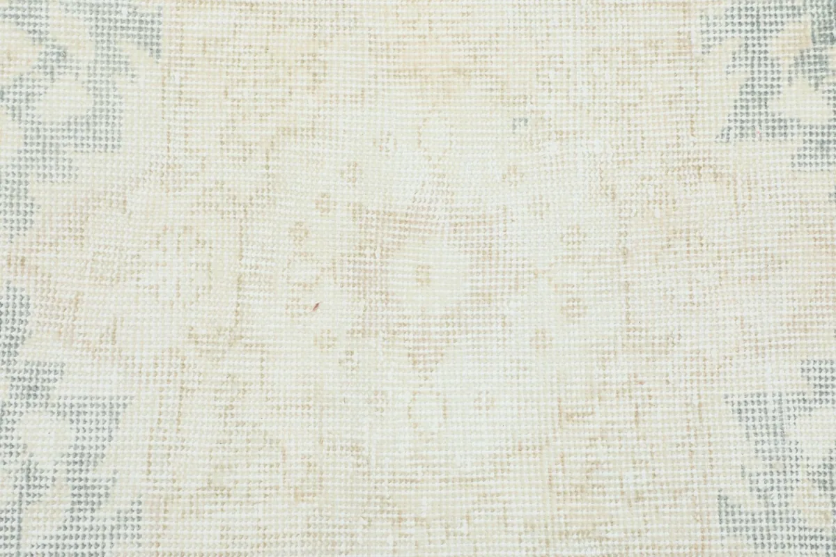 Close-up of the low wool pile texture and subtle color variations on the rug's surface.
