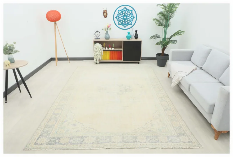 Full top view of the 6'10" x 9'8" vintage ivory Anatolian area rug on a white background
